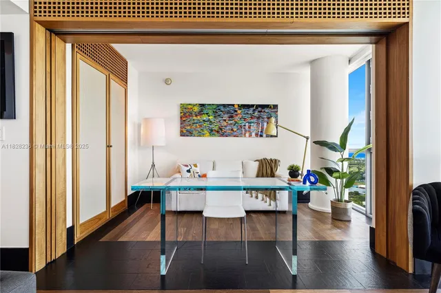 a living room with furniture and a floor to ceiling window