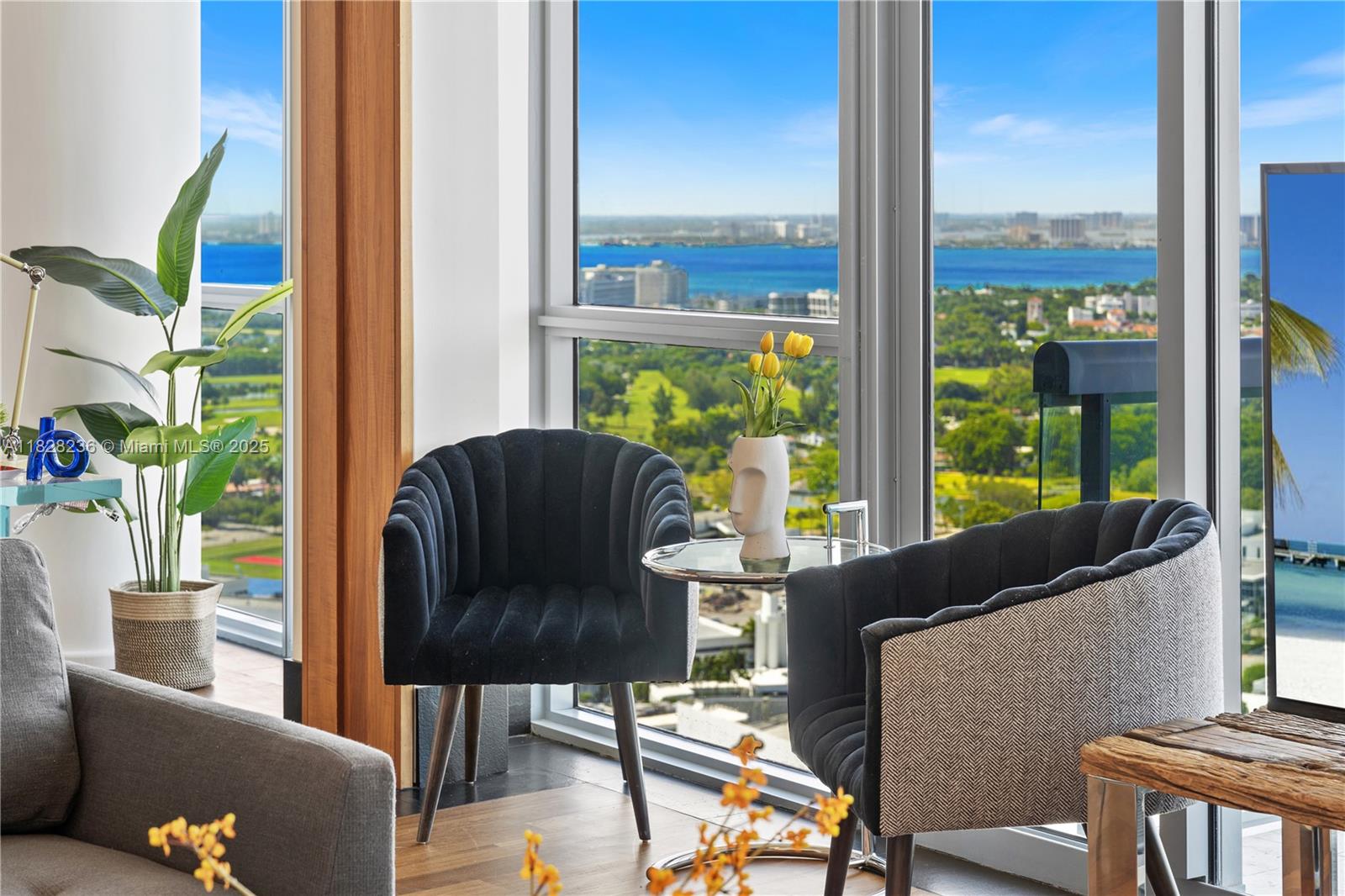 101 20th Street, Unit 3803 Miami Beach, FL 33139 - Photo 9 of 36 a living room with furniture and a floor to ceiling window