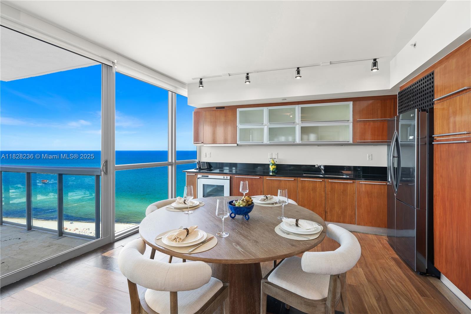 101 20th Street, Unit 3803 Miami Beach, FL 33139 - Photo 10 of 36 a view of a dining room with furniture window and wooden floor