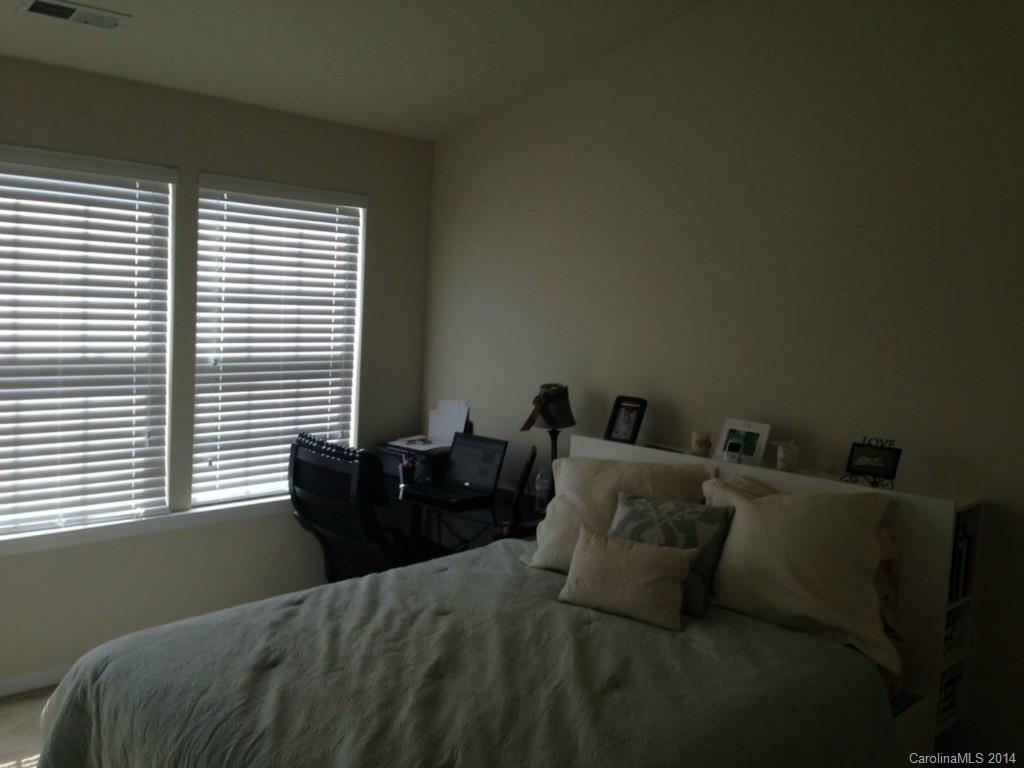 204 Falling Ridge, Unit 145 Belmont, NC 28012 - Photo 14 of 18 a bed sitting in a bedroom next to a window