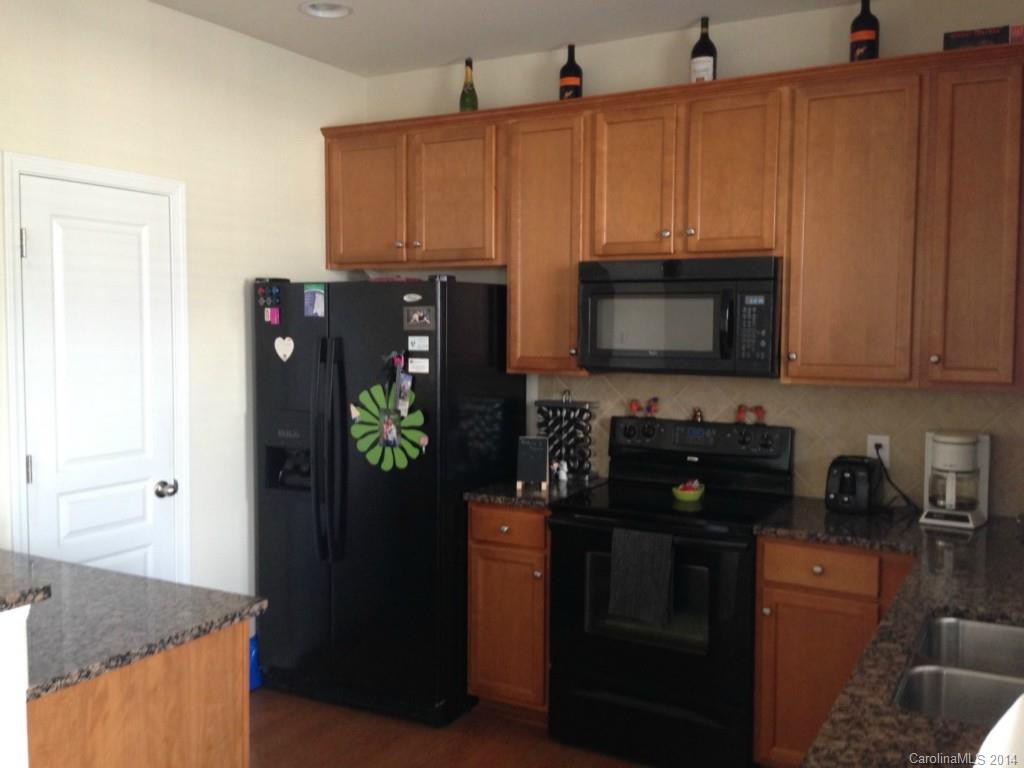 204 Falling Ridge, Unit 145 Belmont, NC 28012 - Photo 3 of 18 a kitchen with stainless steel appliances granite countertop a refrigerator and a microwave