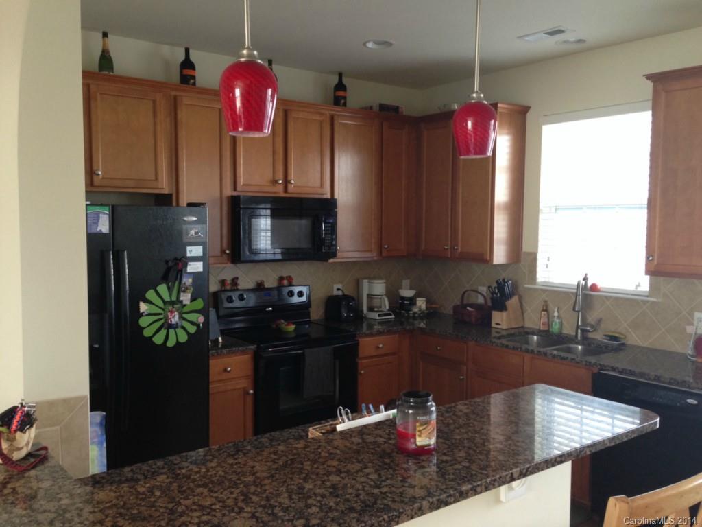 204 Falling Ridge, Unit 145 Belmont, NC 28012 - Photo 4 of 18 a kitchen with a sink a microwave and cabinets