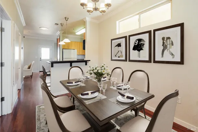 a view of a dining room and hall with wooden floor