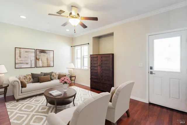 a living room with furniture and wooden floor
