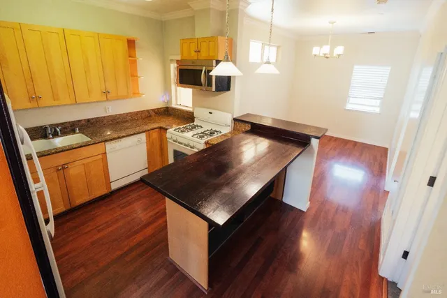 a kitchen with stainless steel appliances granite countertop a stove a sink and a refrigerator