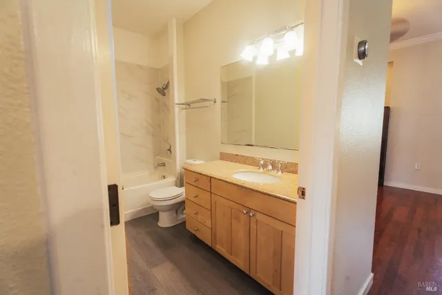 a spacious bathroom with a double vanity sink toilet mirror and shower