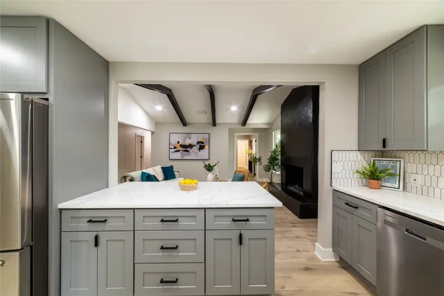 a living room with furniture kitchen and a table