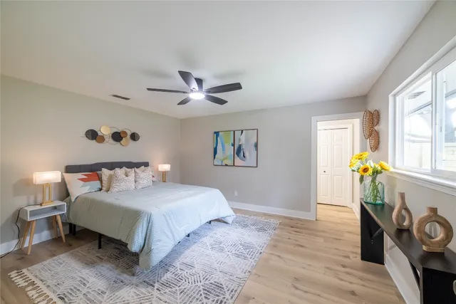 a bedroom with a bed and a ceiling fan