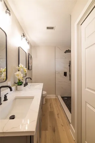 a bathroom with a sink toilet and shower