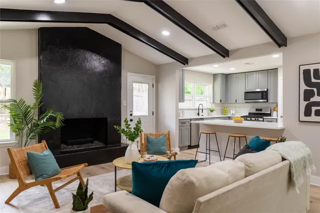 a kitchen with kitchen island a stove a sink and a refrigerator