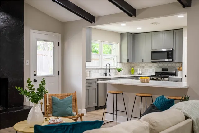 a dining room with furniture and potted plants
