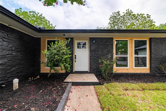 a front view of a house with garden