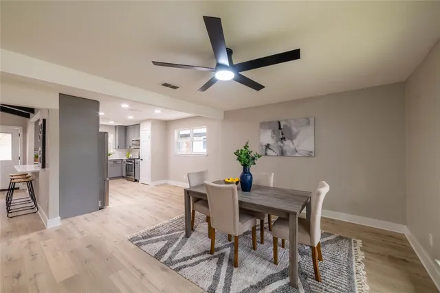 a living room with furniture and kitchen view