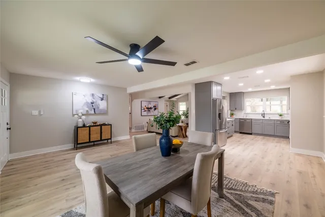 a kitchen with stainless steel appliances a refrigerator sink and cabinets