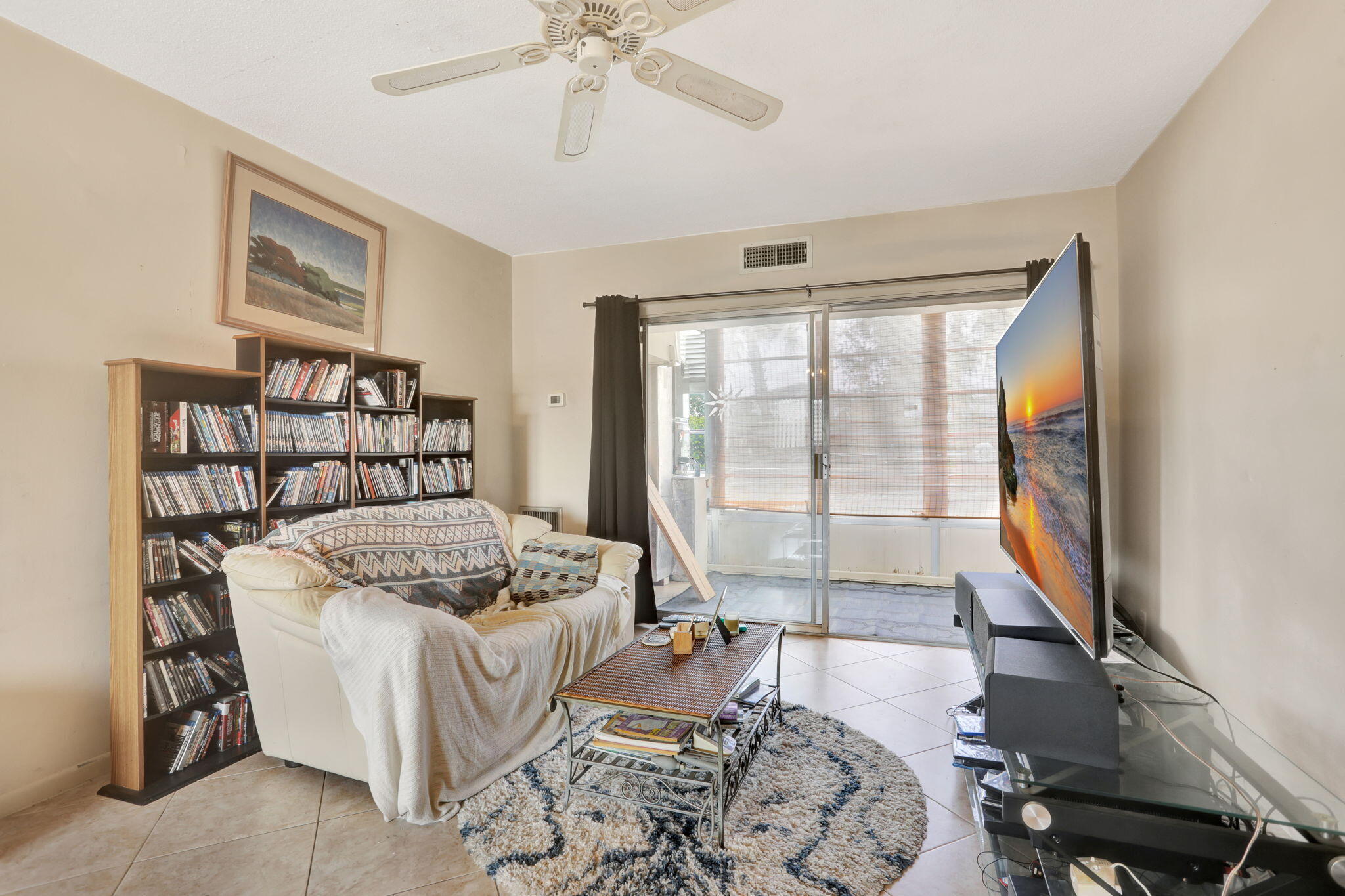 1021 Crystal Lake Drive, Unit 109 Deerfield Beach, FL 33064 - Photo 11 of 21 a bedroom with furniture and a large window