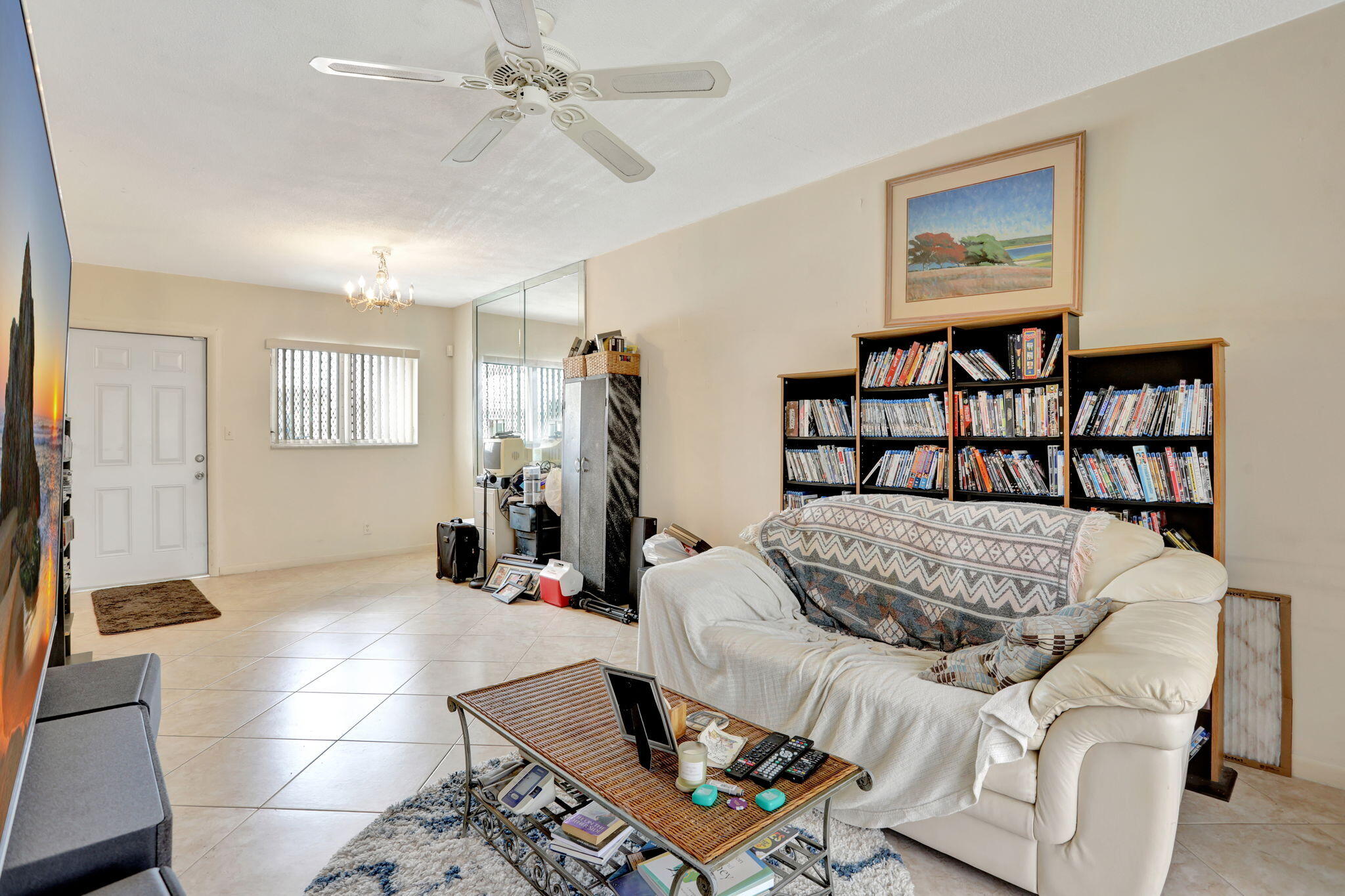 1021 Crystal Lake Drive, Unit 109 Deerfield Beach, FL 33064 - Photo 13 of 21 a living room with furniture flowerpot and a window