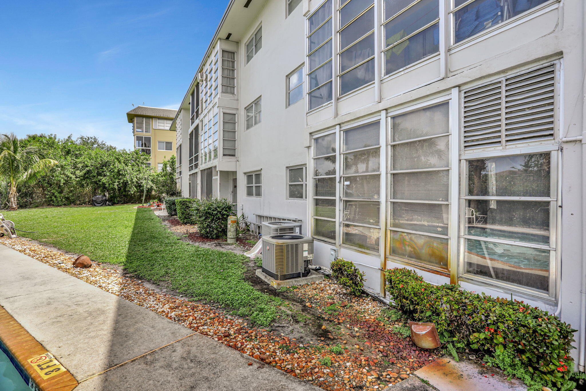 1021 Crystal Lake Drive, Unit 109 Deerfield Beach, FL 33064 - Photo 21 of 21 a front view of a house with a yard