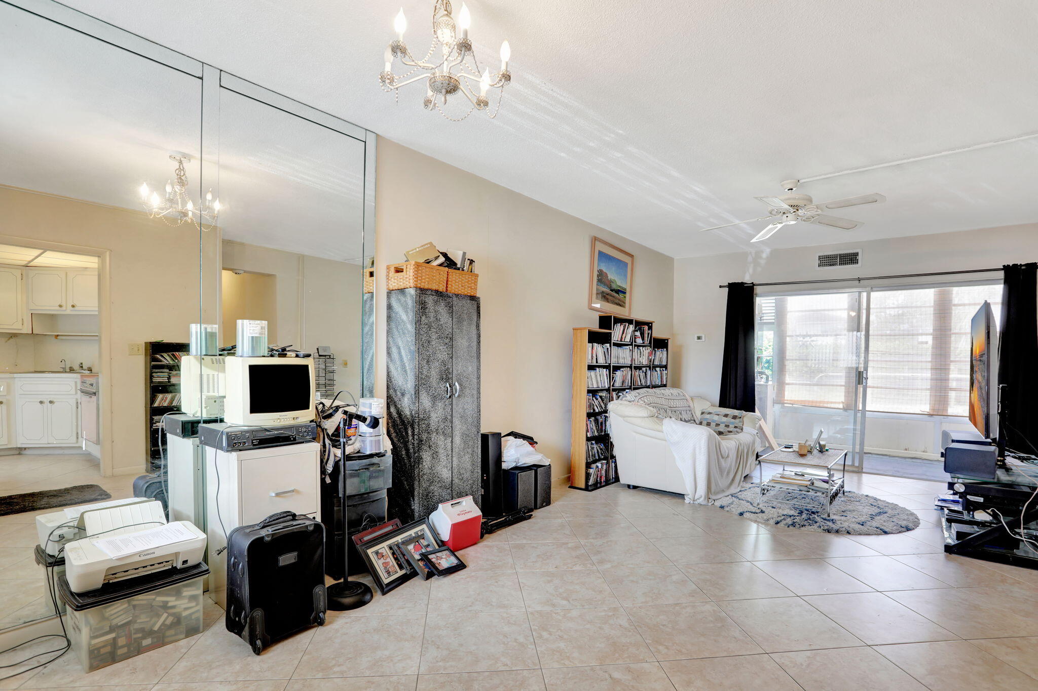 1021 Crystal Lake Drive, Unit 109 Deerfield Beach, FL 33064 - Photo 3 of 21 a view of a livingroom with furniture and a flat screen tv
