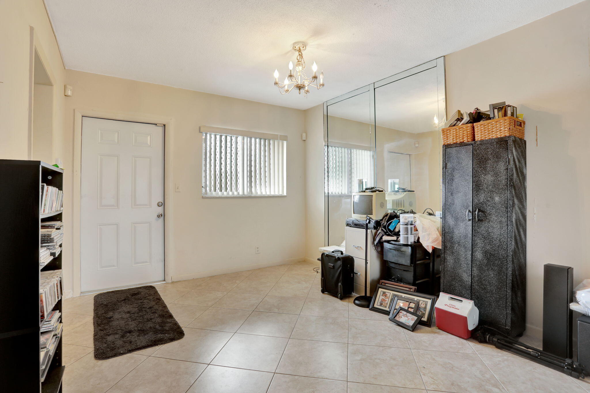 1021 Crystal Lake Drive, Unit 109 Deerfield Beach, FL 33064 - Photo 5 of 21 a room with furniture and a mirror
