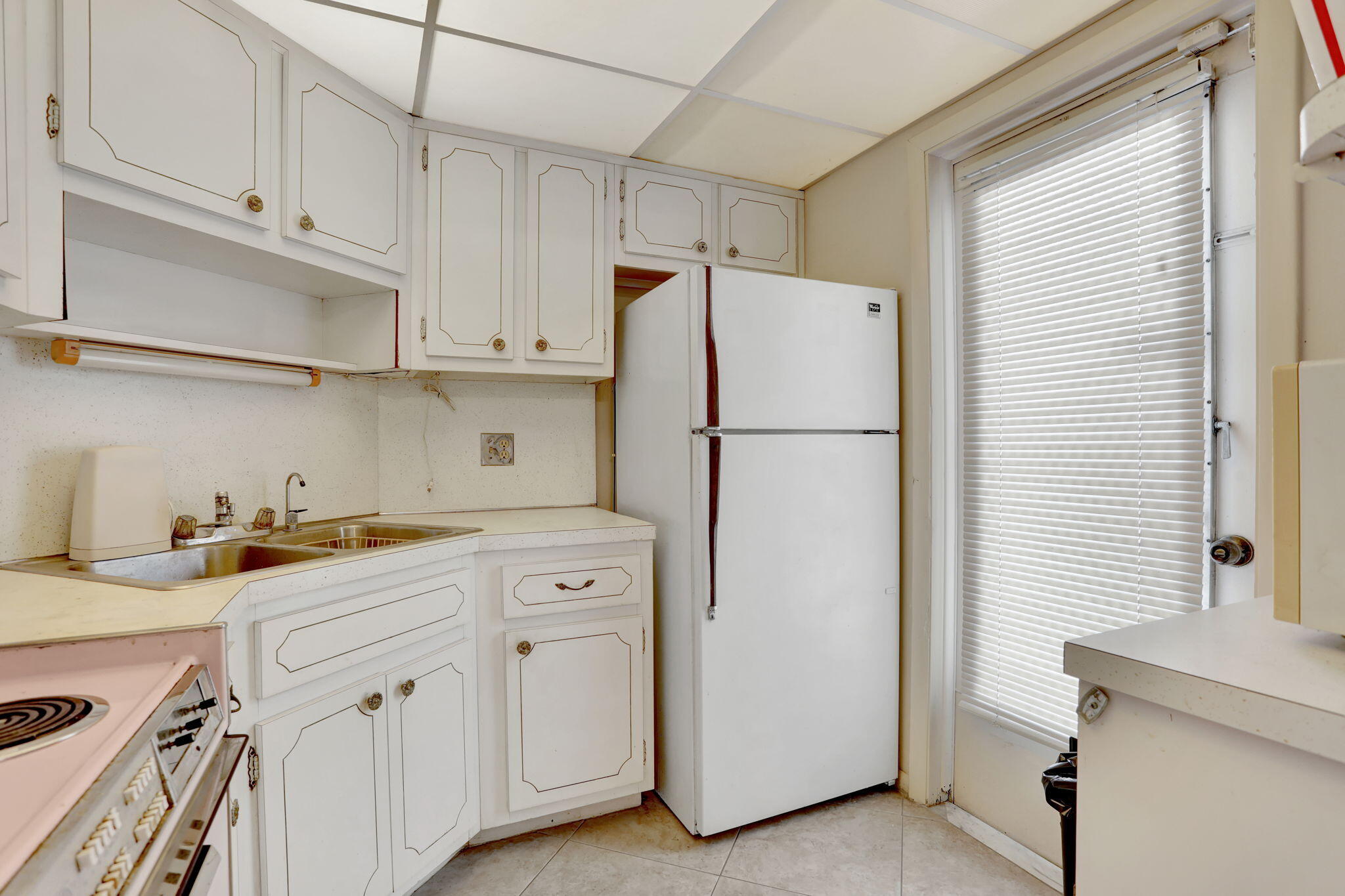 1021 Crystal Lake Drive, Unit 109 Deerfield Beach, FL 33064 - Photo 6 of 21 a white refrigerator freezer sitting inside of a kitchen