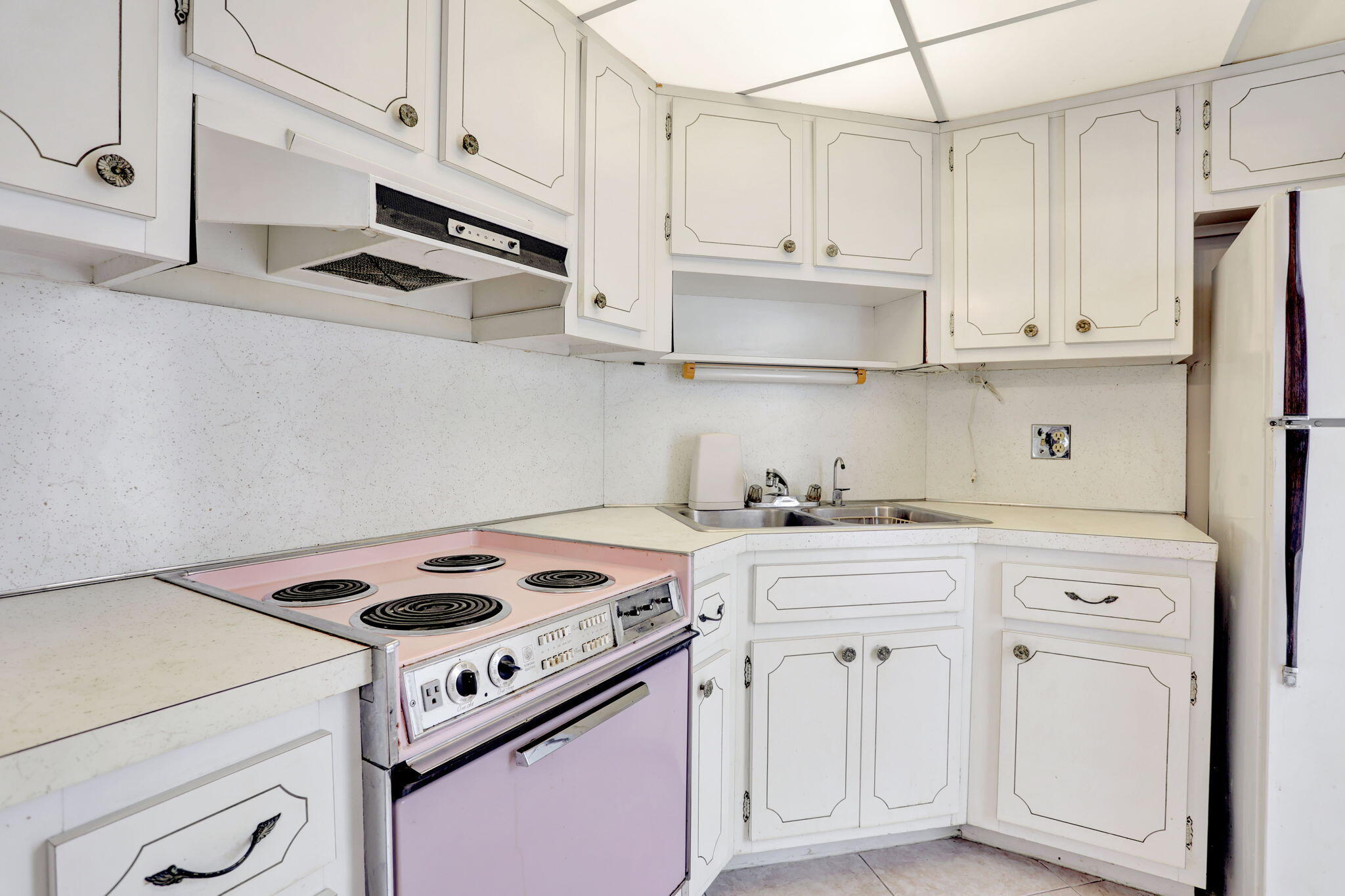 1021 Crystal Lake Drive, Unit 109 Deerfield Beach, FL 33064 - Photo 7 of 21 a kitchen with white cabinets and white appliances