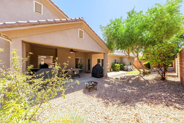 1609 East 10 S Street St. George, UT 84790 - Photo 54 of 68 Expansive backyard featuring a covered patio with an outdoor ceiling fan, concrete patio flooring, and a low-maintenance gravel landscape