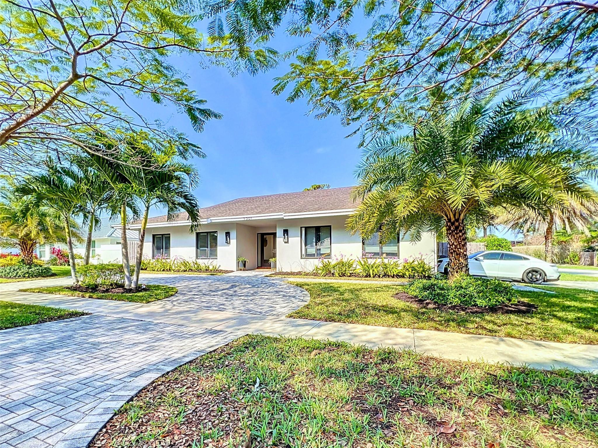 1501 Southwest 17th Street Boca Raton, FL 33486 - Photo 1 of 36 a front view of a house with a yard