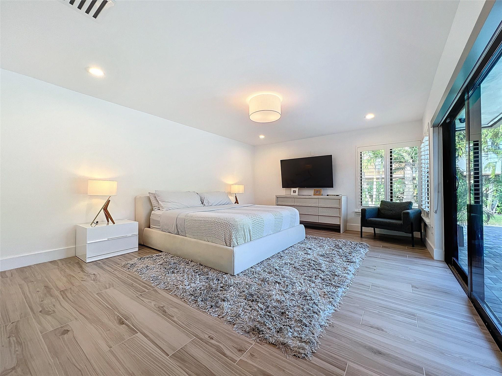 1501 Southwest 17th Street Boca Raton, FL 33486 - Photo 12 of 36 a spacious bedroom with a bed and a flat screen tv