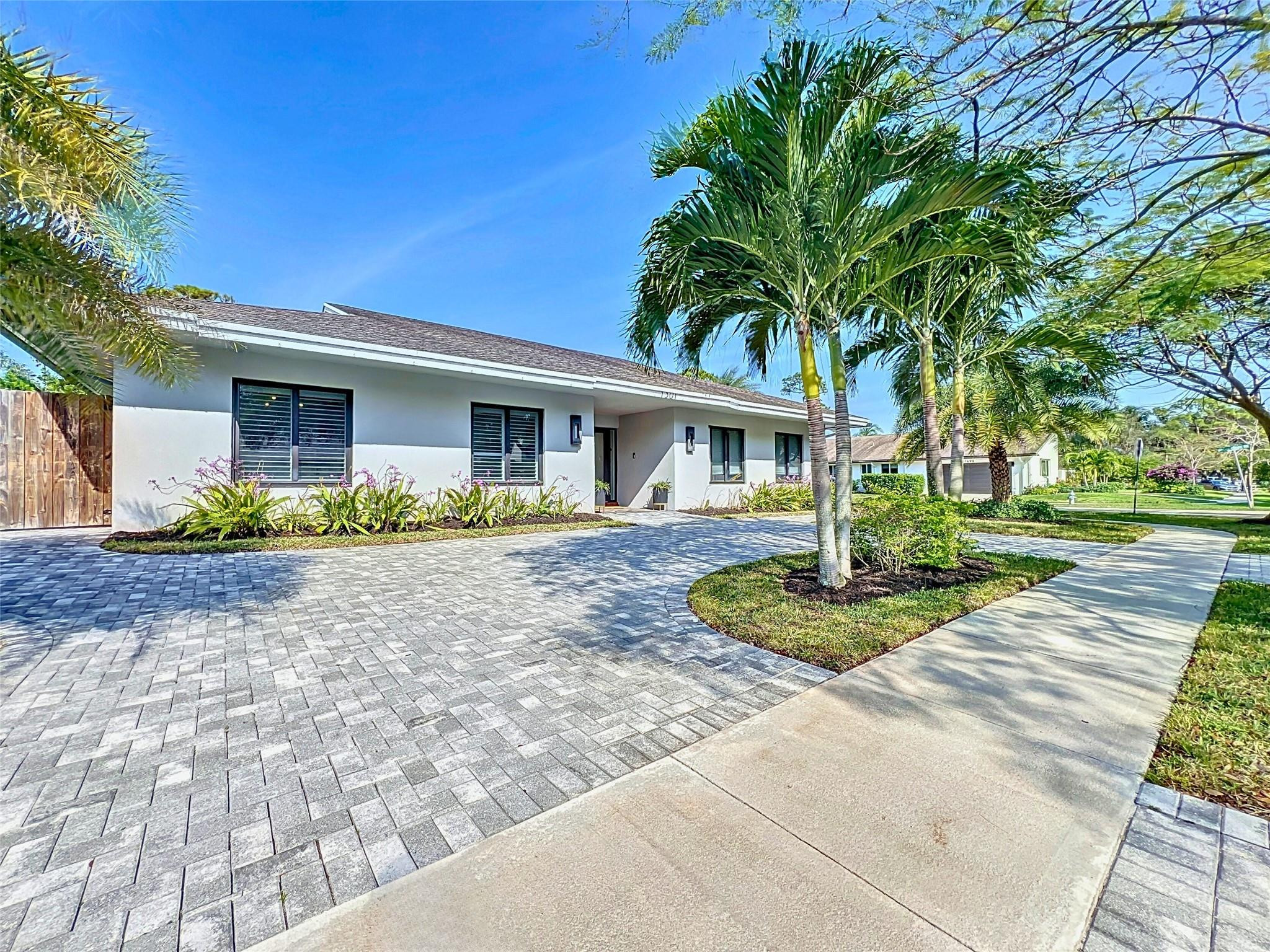 1501 Southwest 17th Street Boca Raton, FL 33486 - Photo 26 of 36 a front view of a house with garden and plants