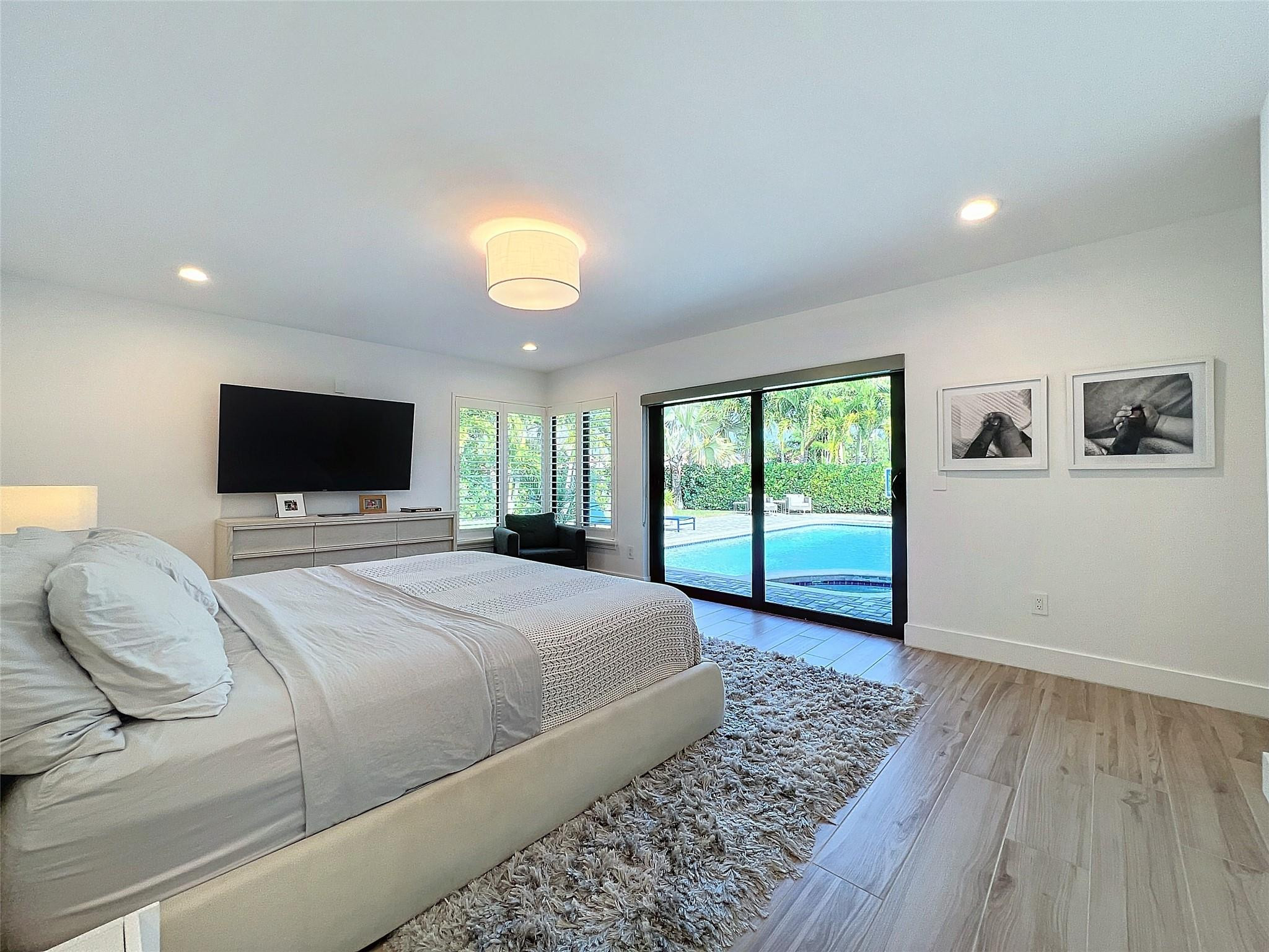 1501 Southwest 17th Street Boca Raton, FL 33486 - Photo 30 of 36 a bedroom with a bed and a flat screen tv