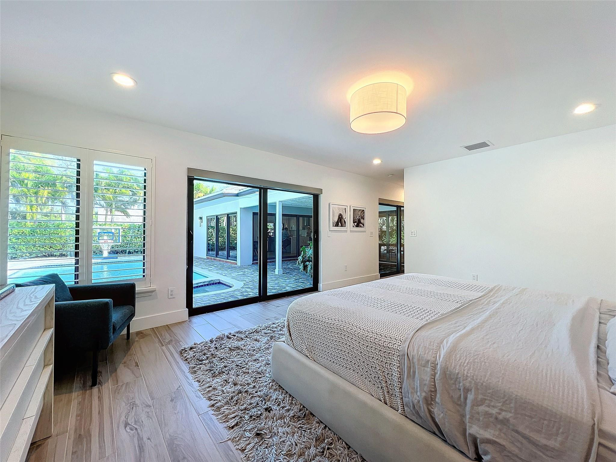 1501 Southwest 17th Street Boca Raton, FL 33486 - Photo 31 of 36 a bedroom with a bed and a large window with outer view