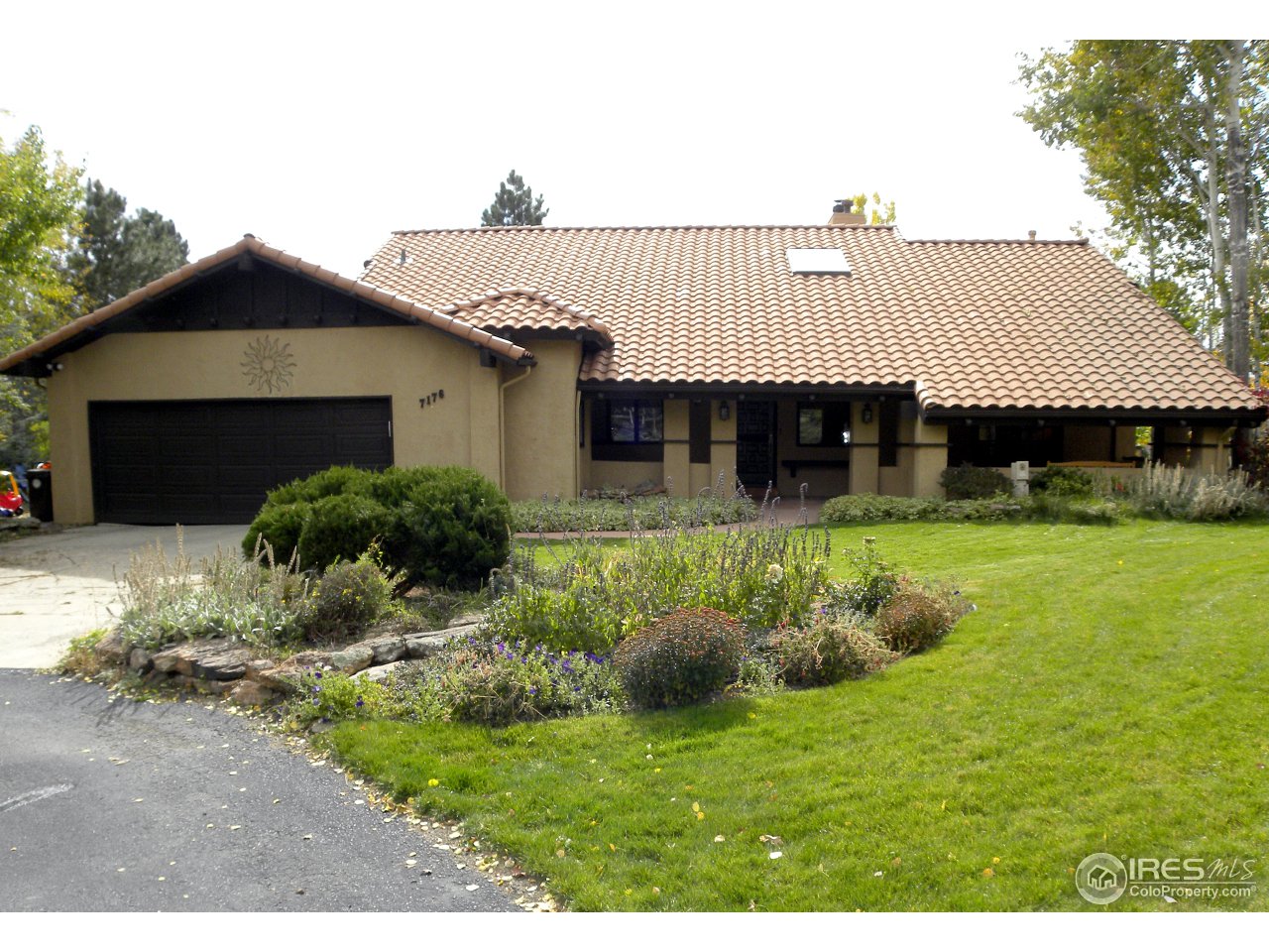 7176 Four Rivers Road Boulder, CO 80301 - Photo 3 of 24 a front view of a house with a yard