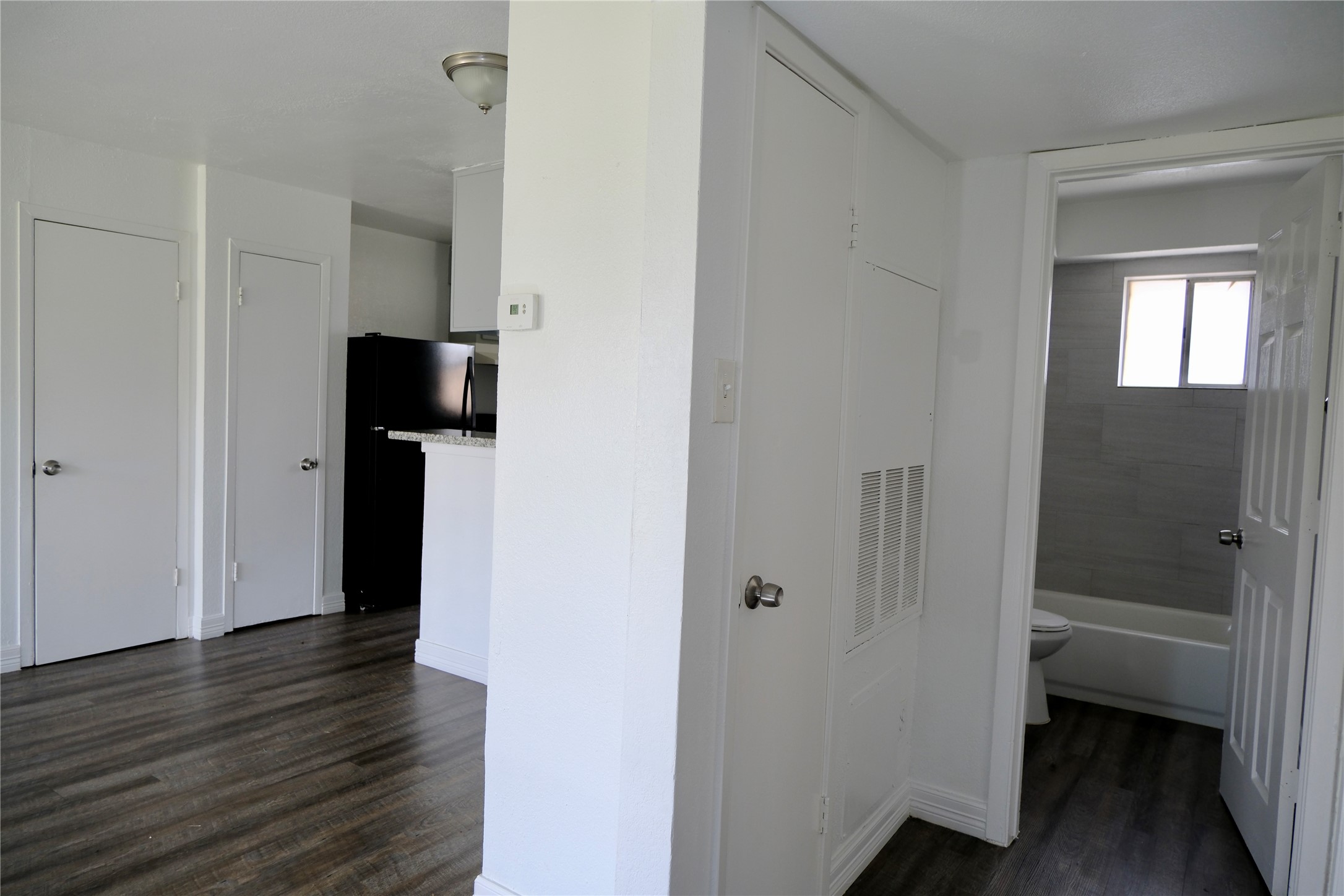 5602 Market Street, Unit 11 Houston, TX 77020 - Photo 11 of 29 Dining and hallway to bathroom in view, Images are for illustrative purposes only and may represent a similar unit. Actual finishes, layout, and features may vary