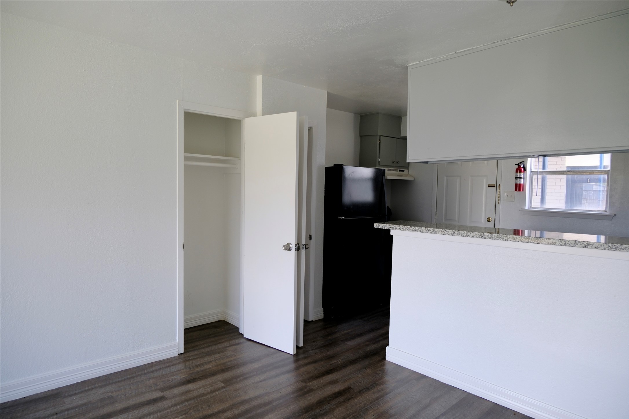 5602 Market Street, Unit 11 Houston, TX 77020 - Photo 7 of 29 Dining with kitchen in view and coat closet, Images are for illustrative purposes only and may represent a similar unit. Actual finishes, layout, and features may vary