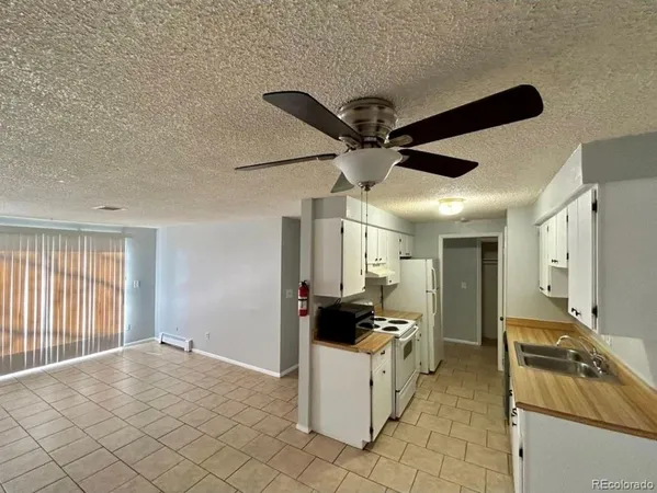 a kitchen with a stove a sink and a refrigerator