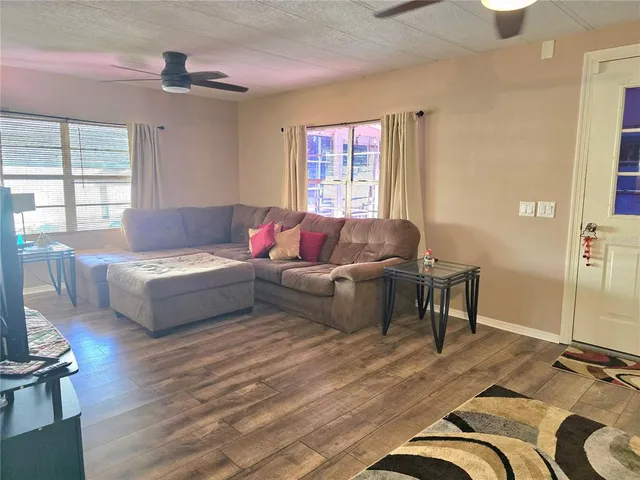 a spacious bedroom with a bed and a chandelier