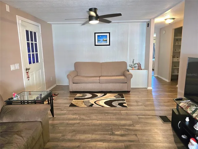 a view of a patio with a dining table and chairs with wooden floor