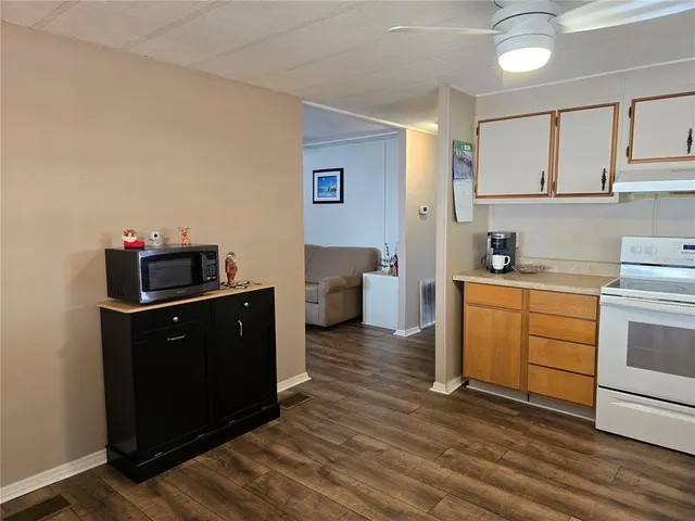 a view of a deck with a table and chairs with wooden floor and fence