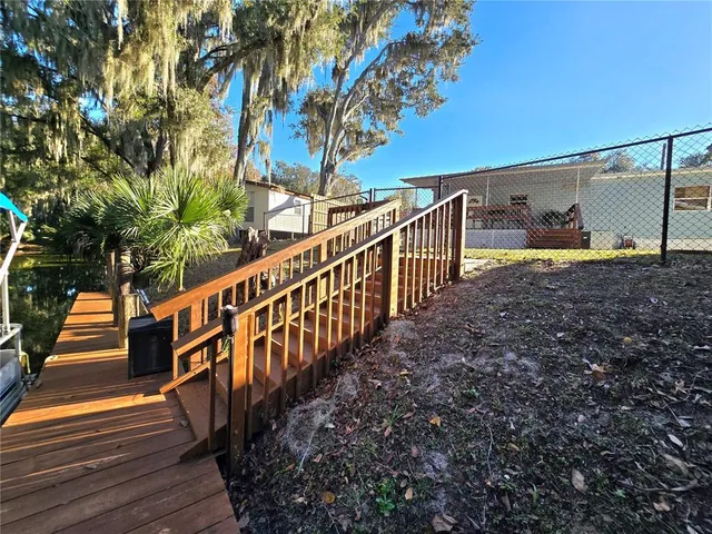 a kitchen with stainless steel appliances granite countertop a refrigerator and a dining table