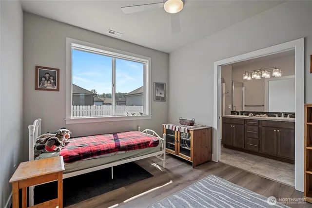 a bathroom with a double vanity sink mirror and shower