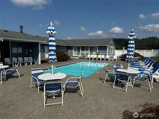 a view of a a dining room with furniture window and wooden floor