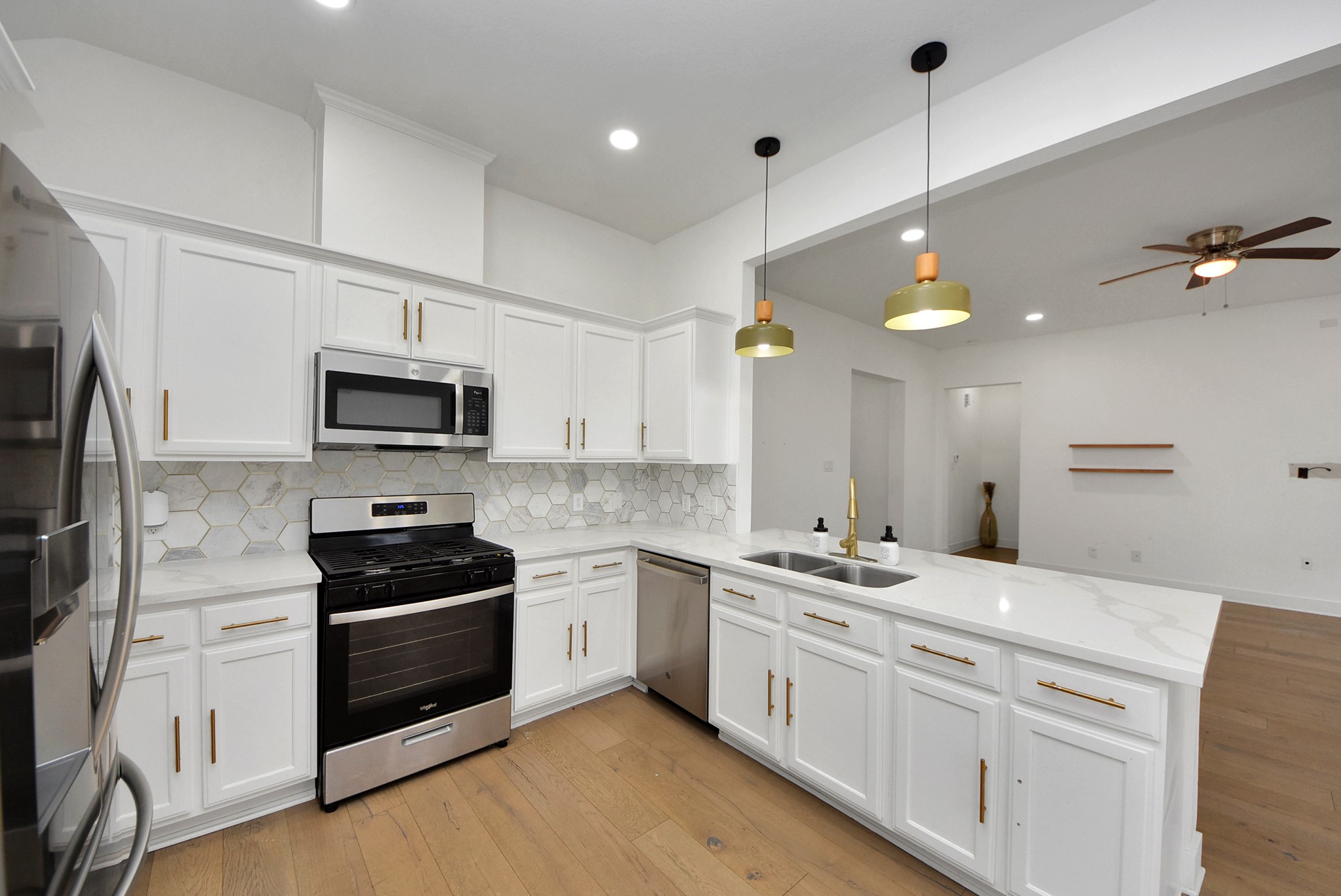 2311 Canfield Street Houston, TX 77004 - Photo 13 of 38 a kitchen with stainless steel appliances white cabinets and sink