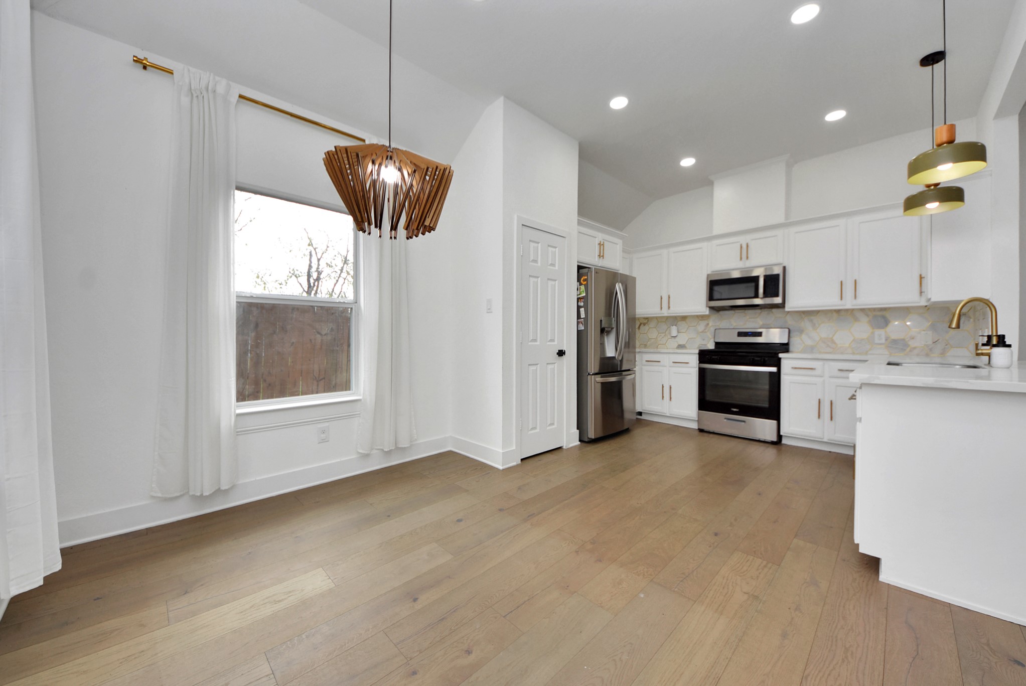 2311 Canfield Street Houston, TX 77004 - Photo 15 of 38 a kitchen with stainless steel appliances granite countertop a refrigerator a stove a sink and a microwave