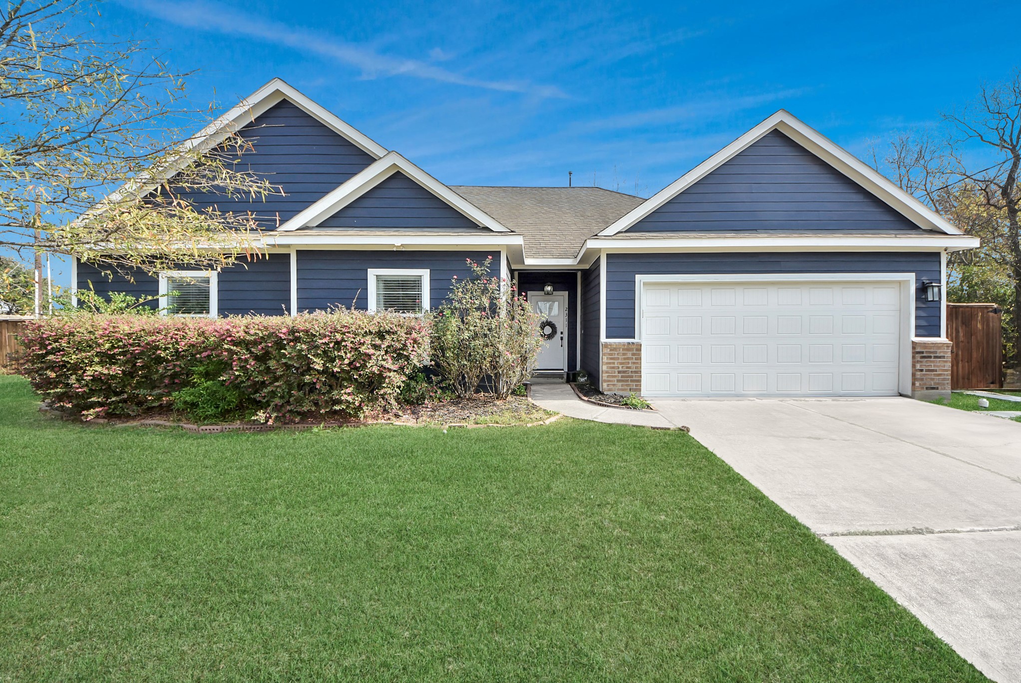 2311 Canfield Street Houston, TX 77004 - Photo 3 of 38 a front view of a house with a yard and garage