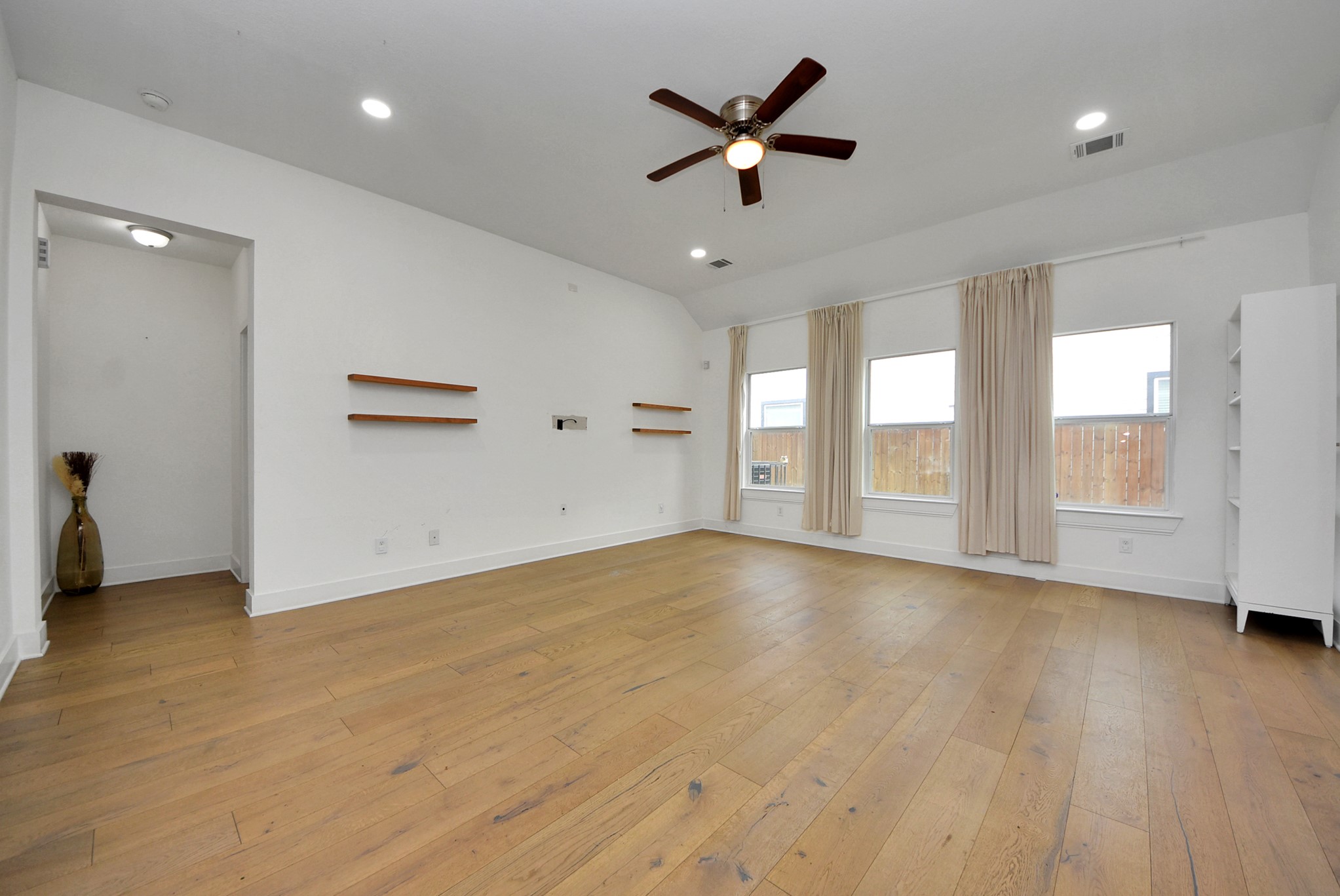2311 Canfield Street Houston, TX 77004 - Photo 7 of 38 an empty room with wooden floor and windows