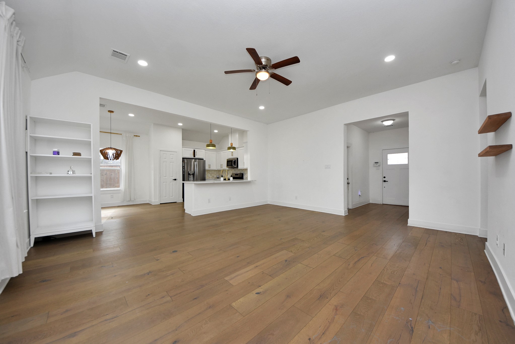 2311 Canfield Street Houston, TX 77004 - Photo 9 of 38 a view of a livingroom with a furniture hardwood floor and a ceiling fan