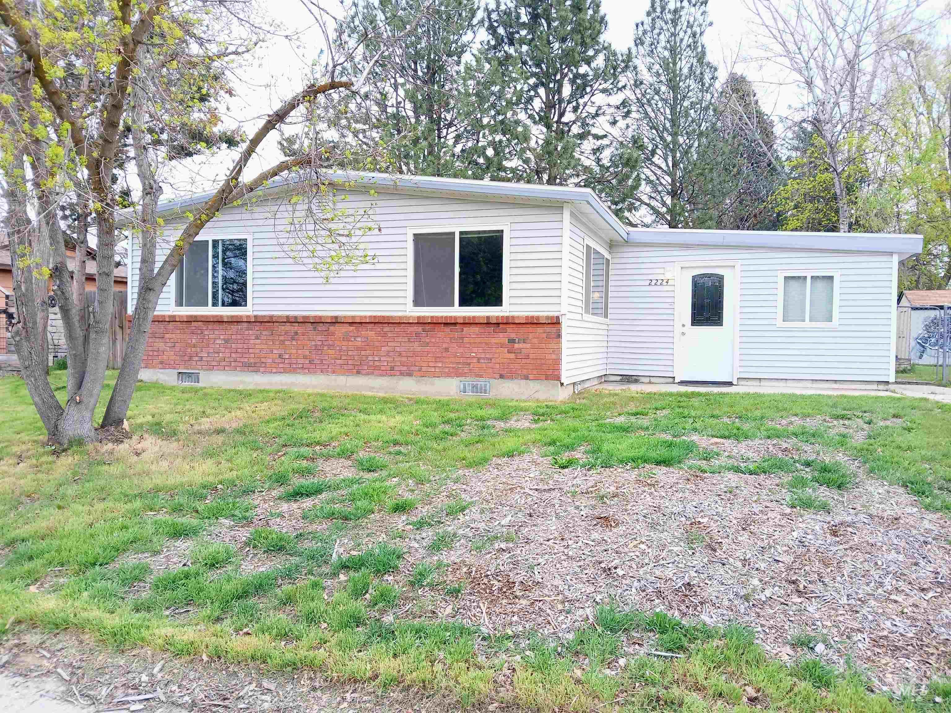 View of front facade with brick siding and a front yard