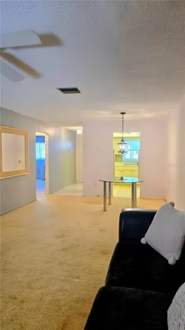 a view of a livingroom with a furniture and a ceiling fan