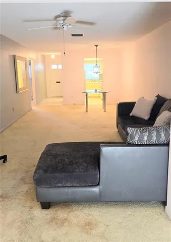 a bedroom with a bed and a ceiling fan