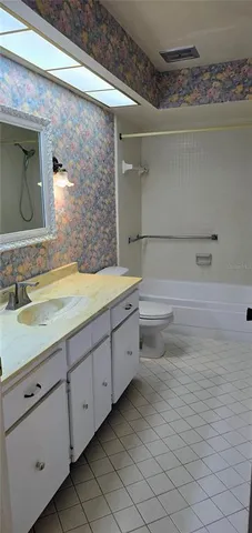 a bedroom with a bed and a mirror